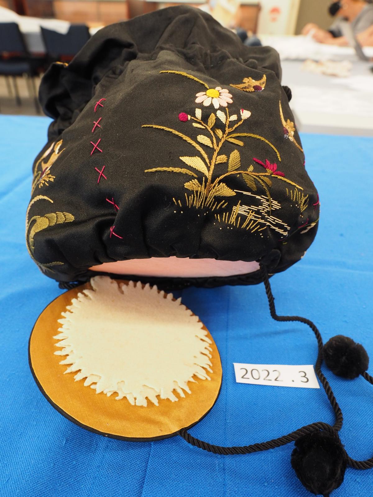 Embroidered bag showing flap base