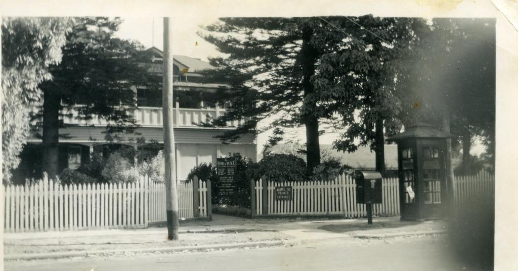 a) Home of Peace entrance, building