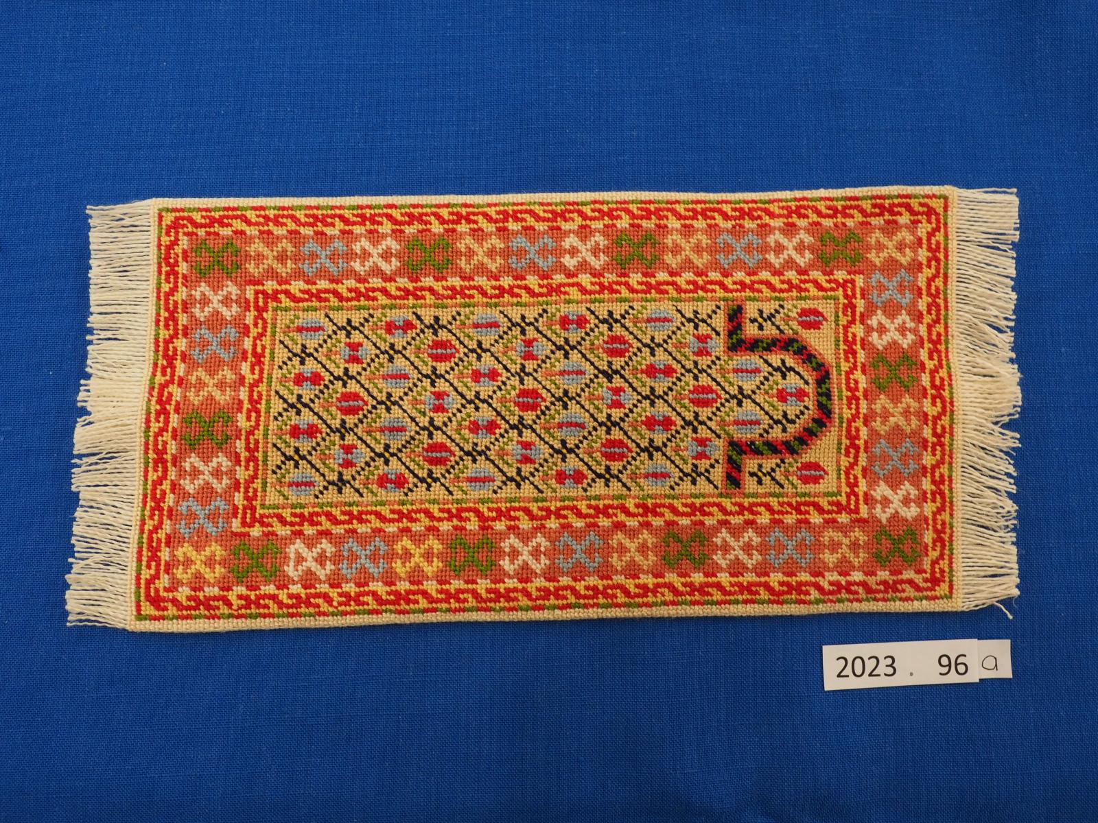 Miniature embroidered rug