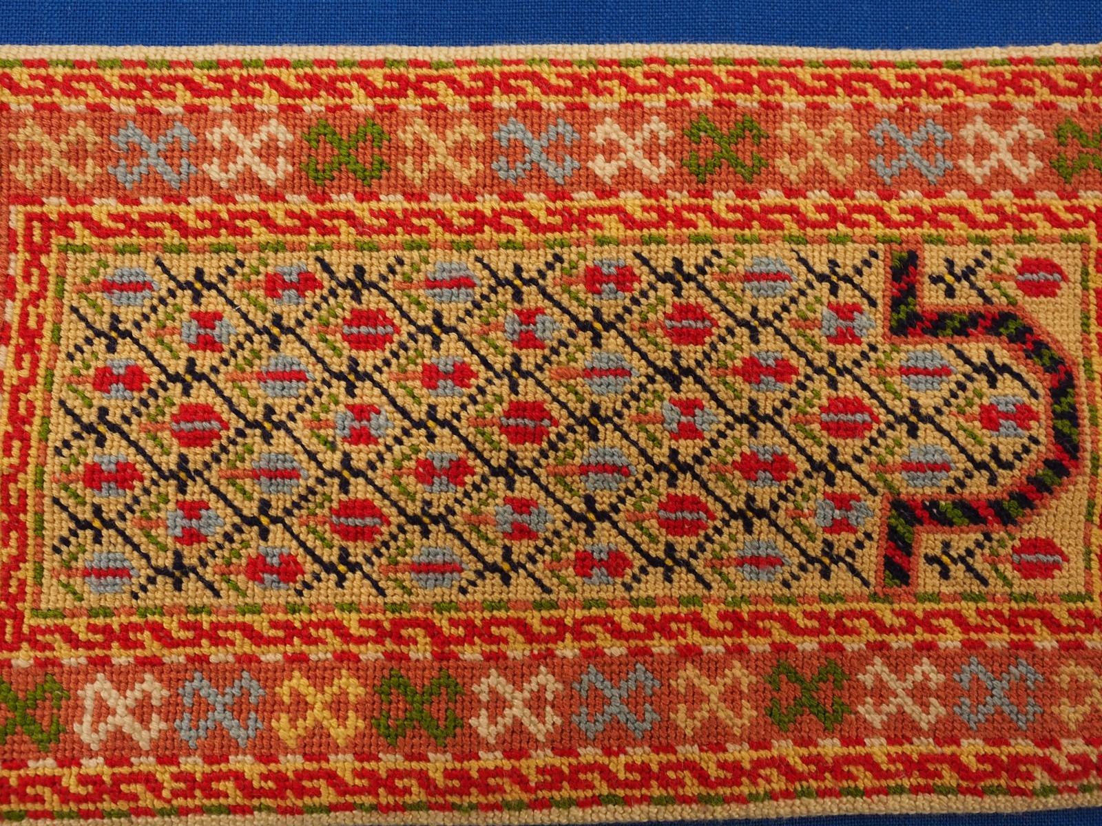 Miniature embroidered rug detail