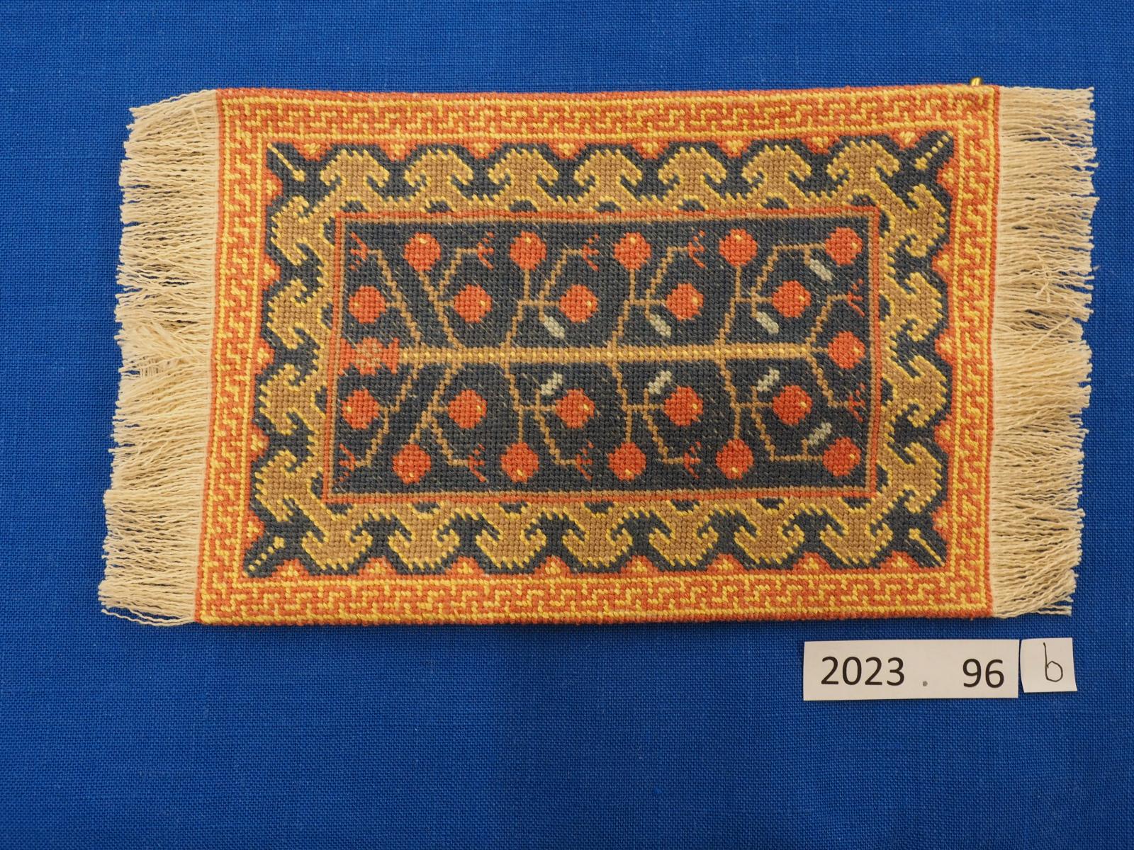 Miniature embroidered rug