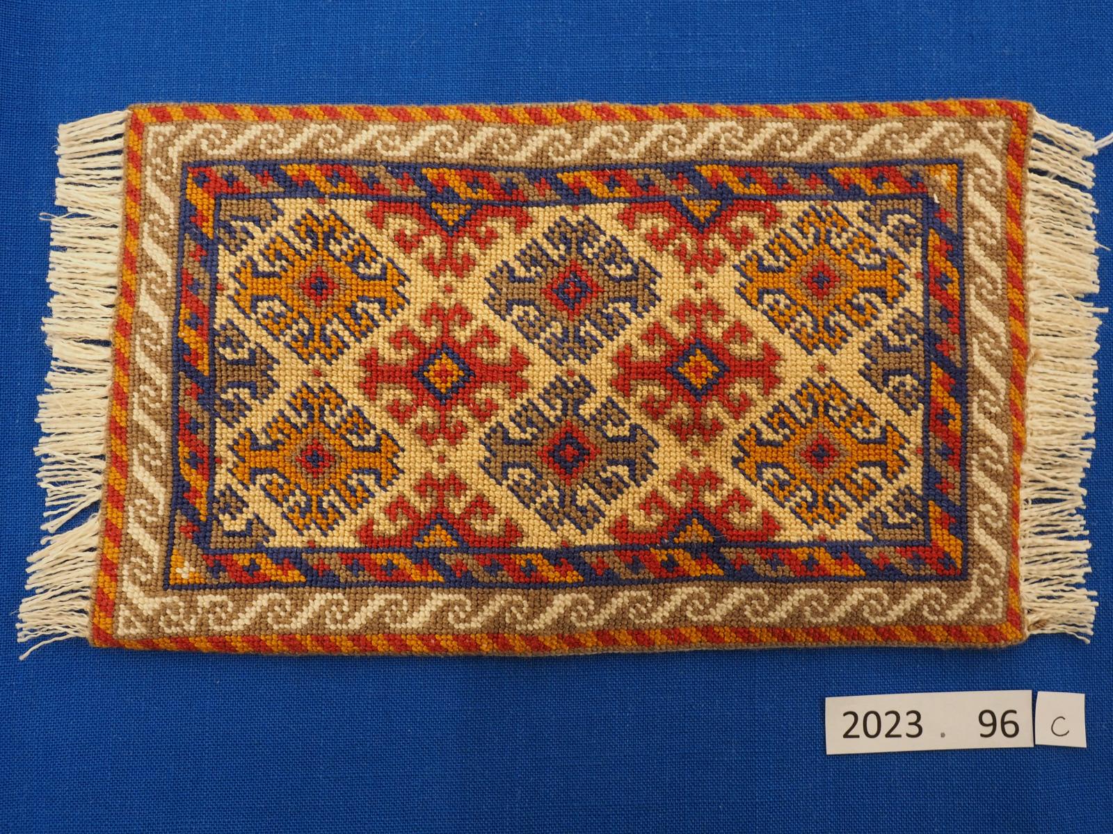 Miniature embroidered rug