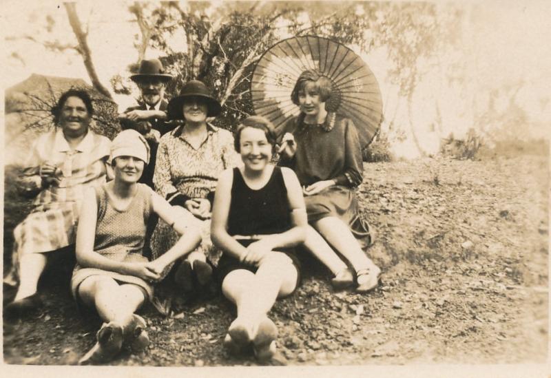 People sitting on river bank