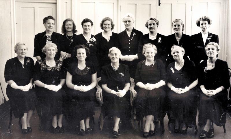 black and white photo of 15 women