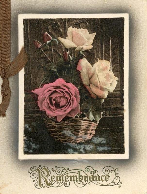 sepia and pink image of a rose in baskets with Rememberance written under in scroll script