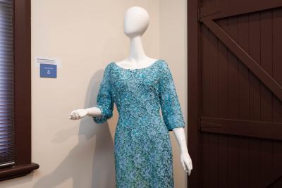 Blue dress, heavily beaded and highly decorative.  Round neck, 3/4 sleeves