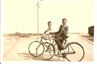 Photograph of two boys with bicycles