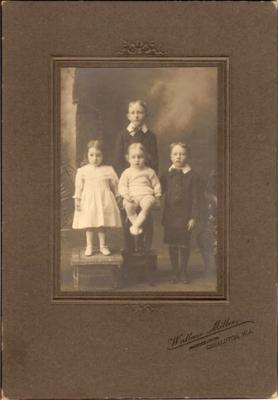 Mounted studio photograph of four children