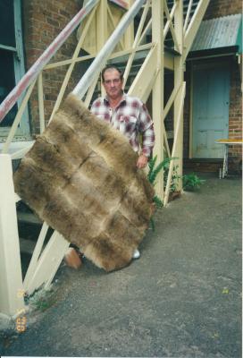 Man holding a Kangaroo Skin Rug