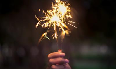 hand holding a lit sparkler