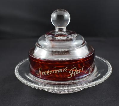 Small American Great White Fleet commemorative round pressed ruby and clear glass butter dish.