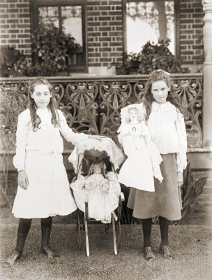 Two Girls With Pram And Dolls