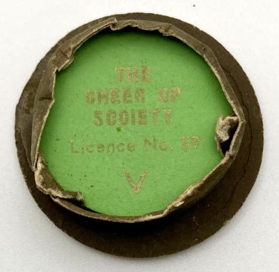 Underside of Cheer-Up Society fundraising pin in shape of Army peaked cap