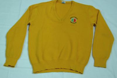 Yellow woolen long-sleeve jumper with a v-neck. There is an embroidered logo on the left of the chest with the words WESTFIELD BRIGADE around a white circle. Inside the circle is depicted green leaves on the left and red flames on the right.