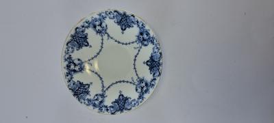 saucer with blue flower around edges
