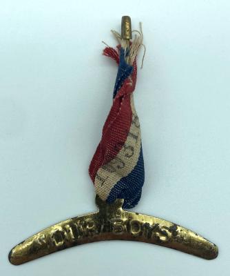 WWI fundraising metal boomerang on a tricolour ribbon supporting 'Our Boys'