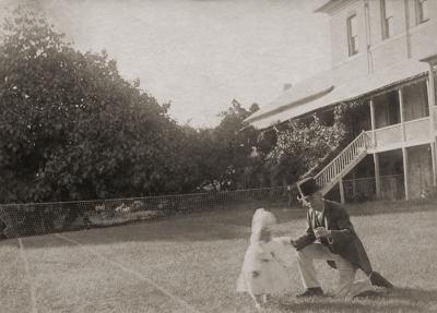 Child And Adults On A Tennis Court