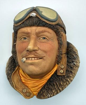 Painted plaster wall hanging depicting Royal Flying Corps pilot 1917