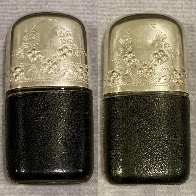 Hip flask with leather base cover and silver lid