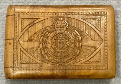 Front of souvenir timber case featuring carved South African Engineers badge