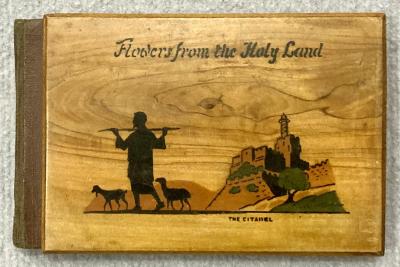 Front cover of sSouvenir olive wood album containing flowers and views from the Holy Land