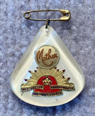 Perspex sweetheart brooch depicting rising sun badge - red