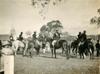 Black and White Photograph of Men on Horseback