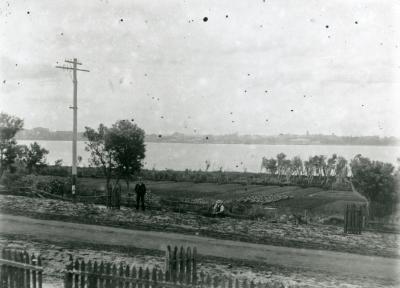 Black and white photo of market gardens by a river