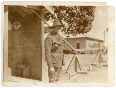 Photo showing Pte. Eric BANNISTER in uniform and armed, standing outside sentry box.