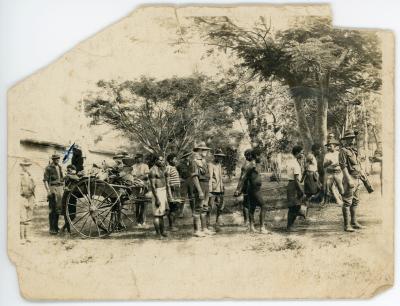 Australian soldiers and New Guinea natives with a wagon of supplies.