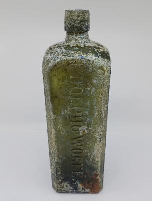 Green glass bottle - Udolpho Wolfe