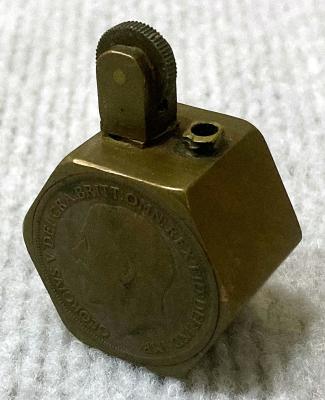 WWI era hexagonal metal cigarette lighter decorated with two coins