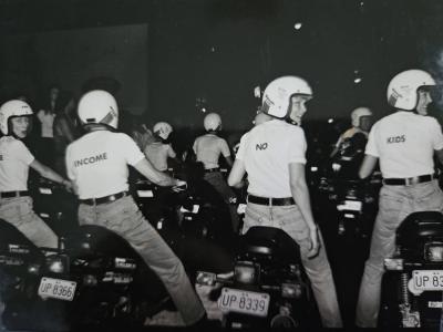 black and white photo of people on motorbikes