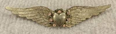 Silver tone sweetheart brooch featuring wings with central heart and pink stones
