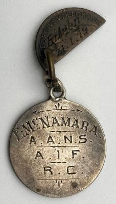 Identity disc and love token made from coins relating to A.A.N.S. nurse Eileen McNamara
