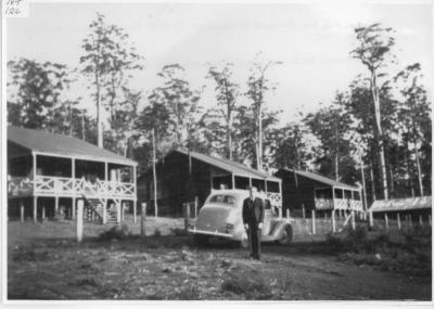 Dr. William H J Cole in front of his 1937 Ford V8 Sedan in Nannup District C.1942