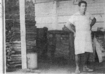 Lino Nicolao, Baker, next to wood fired oven, one of the few in operation at this time in Western Australia.  Newspaper clipping May 5 1977