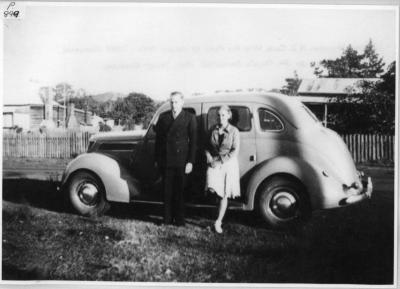 Dr. William H J Cole with his Ford V8 sedan 1942 - lady unknown