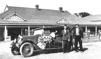 Augusta Hotel (Fishing excursion) with their vehicle parked in front of the hotel (Smith's?)