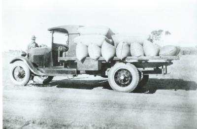 Black and White photograph Truck load of grain.  Looks like a ORB Model Ford