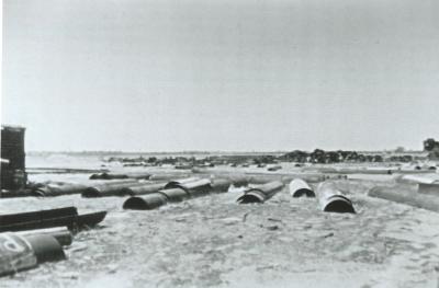 Black and White photograph Electweld - salvaged halves to be welded into pipes