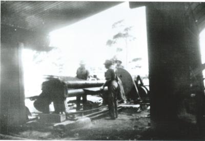 Black and White photograph Rejected steel plate from pipes being rolled flat for general fabrication