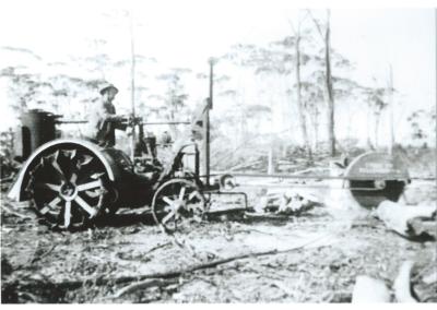 Black and White photograph Patented circular saw on Fordson tractor with gas producer cutting timber for charcoal