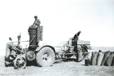 Black and White photograph.  Daadenning Creek.  John Deere with gas producer and AL Harvester with Geoff Cole