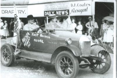 Black and white photograph.  Back to  Kellerberrin weekend street parade. Gilbert Gardiner driving bull nose Morris