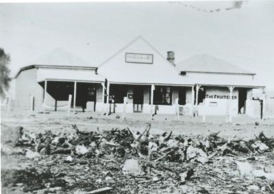 Black and white photograph.  AC Lowes store - Later Lowe Bros.  East of Street and North of Post Office, Doodlakine