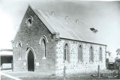 Black and white photograph.  Methodist Church after completion.  New Manse on left