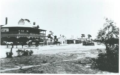 Black and white photograph.  Kellerberrin Hotel and Massingham Street circa 1909. First Funeral ?  Horse drawn hearse