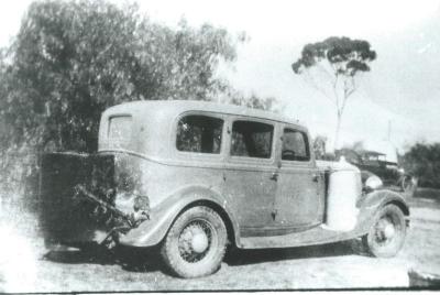 Black and White photograph.  Electweld gas producer fitted to a car