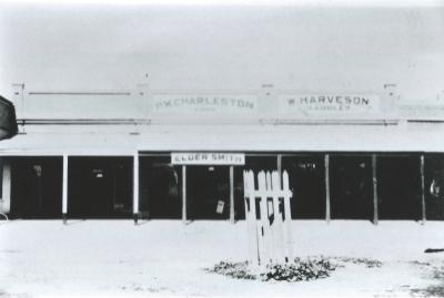 Black and White photograph.  Massingham street shops after rebuilding Puddey's shop